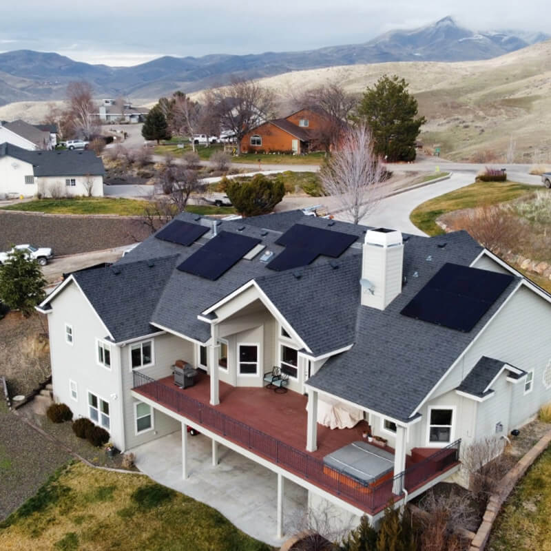 Aerial view of a house with solar panels.
