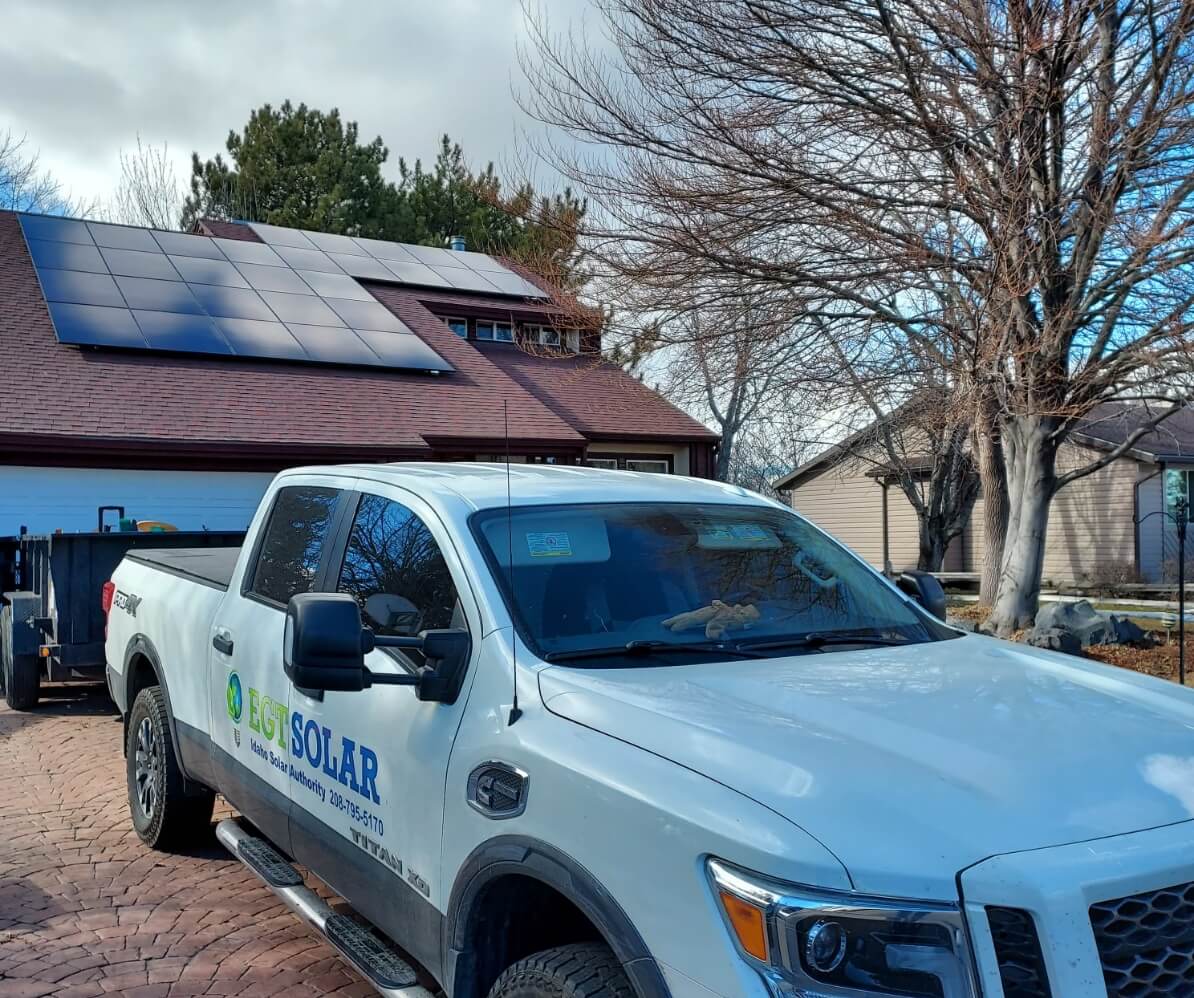 EGT Solar truck in front of a house with solar panels.