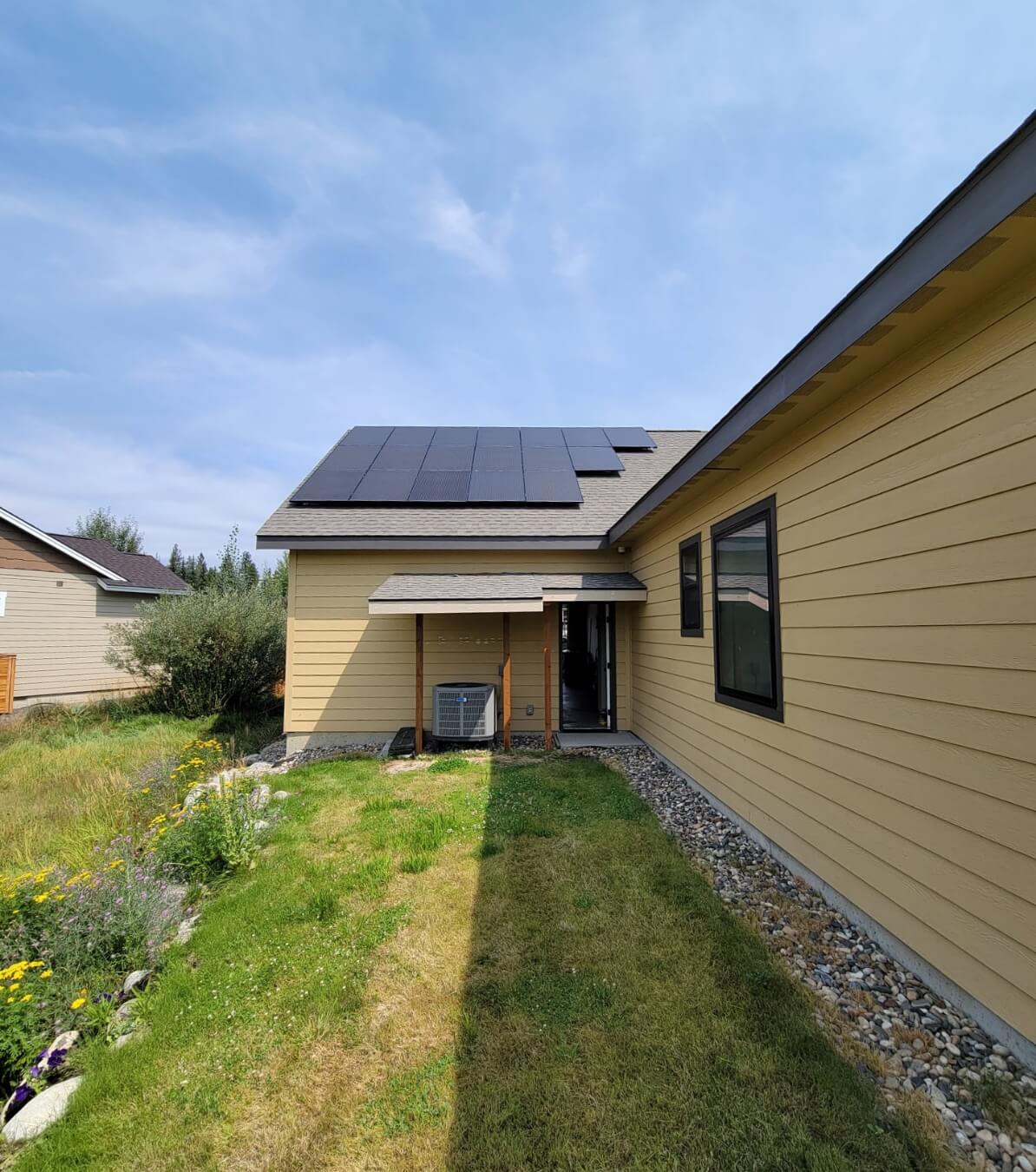 Side view of a house with solar panels.